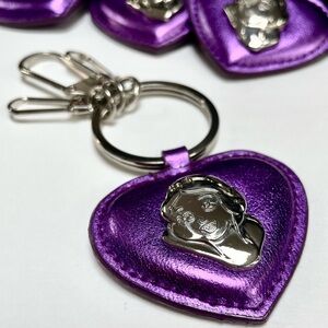 Fourteen (14) Disney Snow White Keychains
Purple with Silver Emblem and Hardware